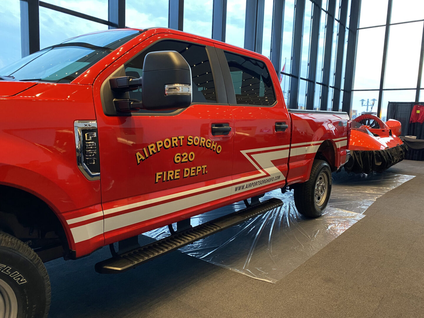 A red truck with the words airport squad 5 2 0 fire dept on it.