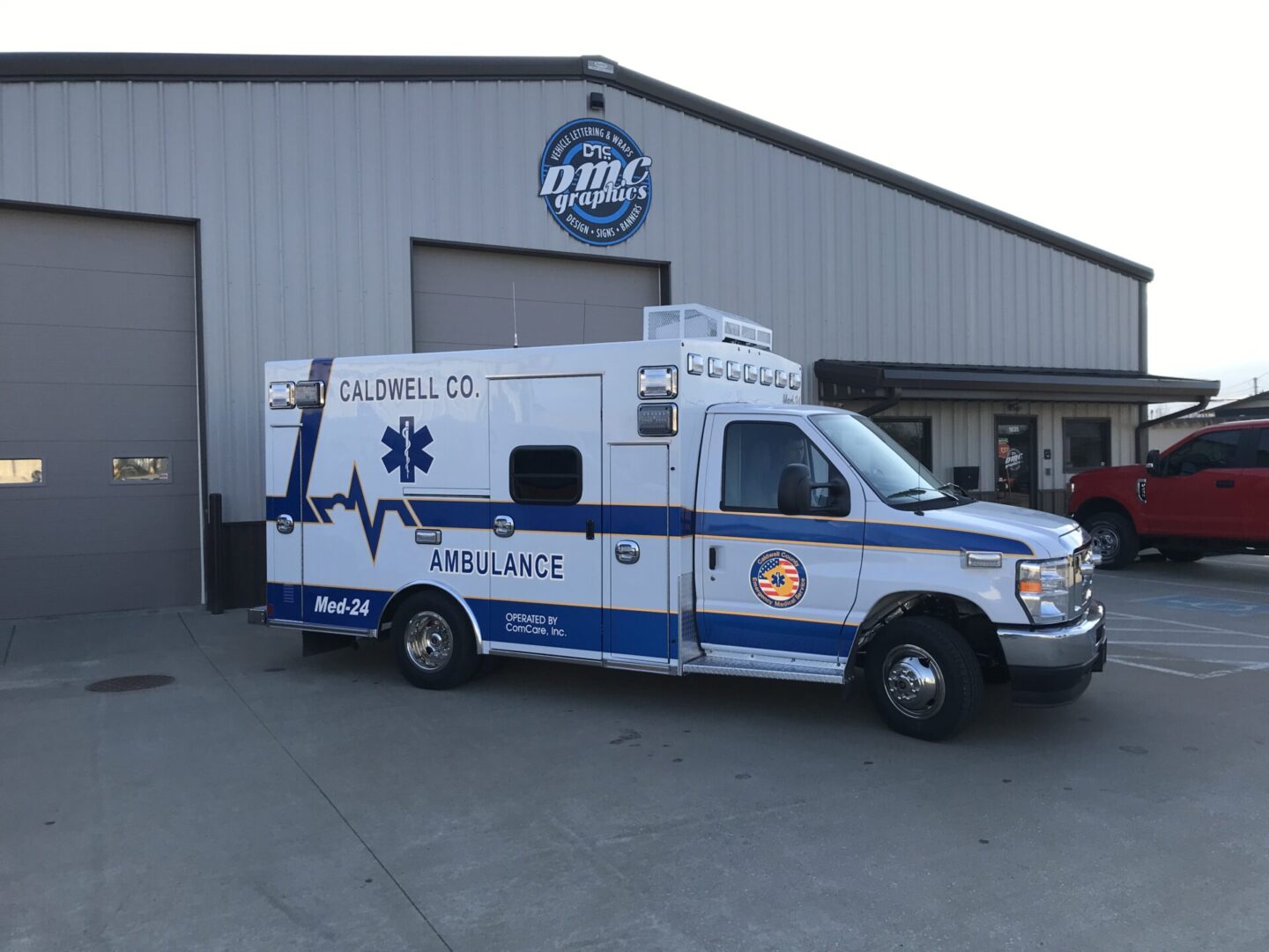 A white and blue ambulance parked in front of a building.