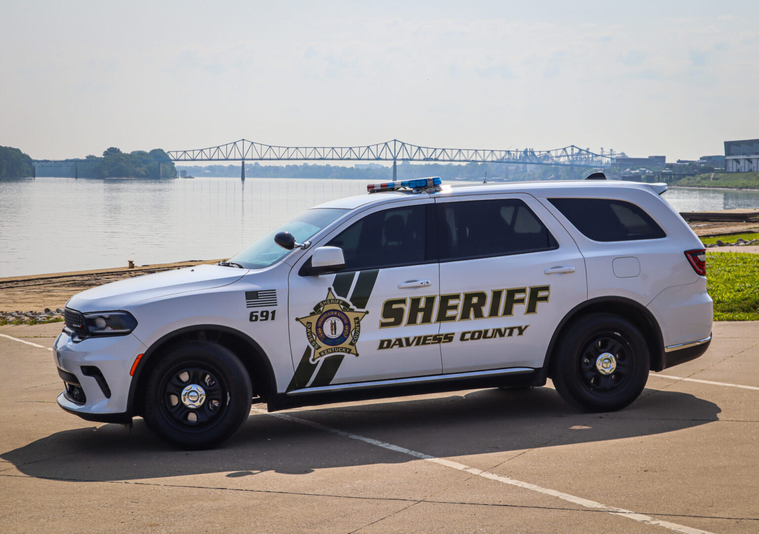 A white sheriff car parked on the side of a road.