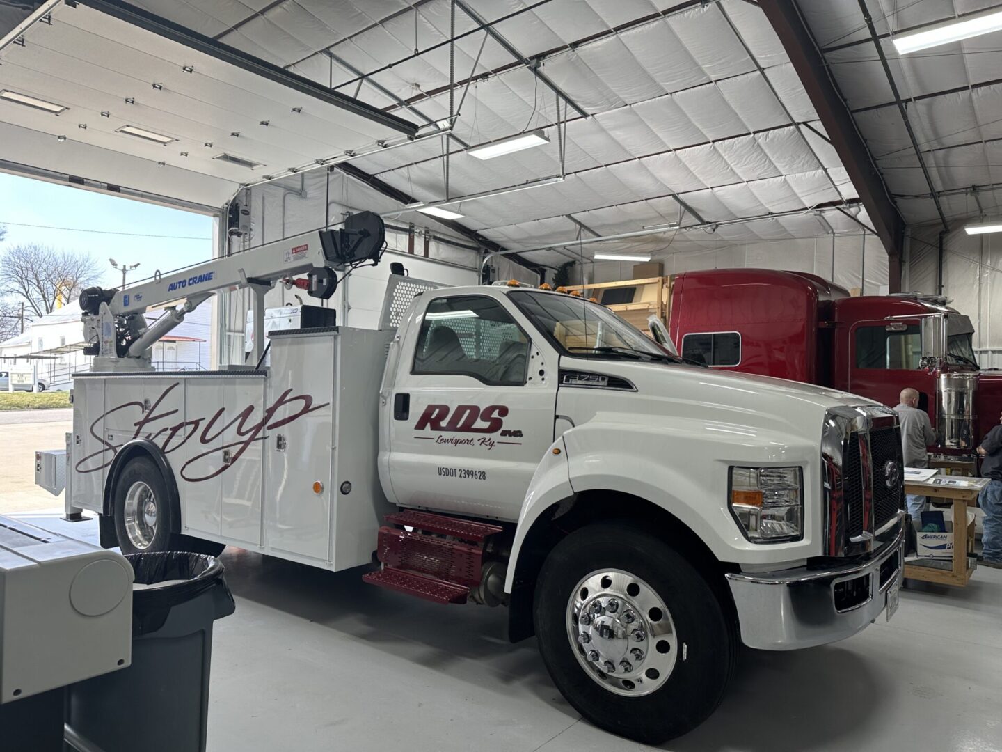 A white truck is parked in the garage.