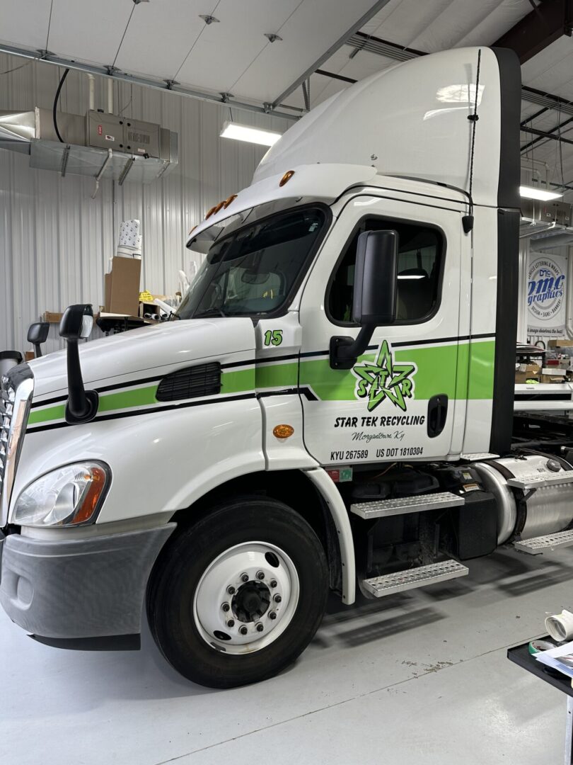 A white semi truck with green stripes on the side.