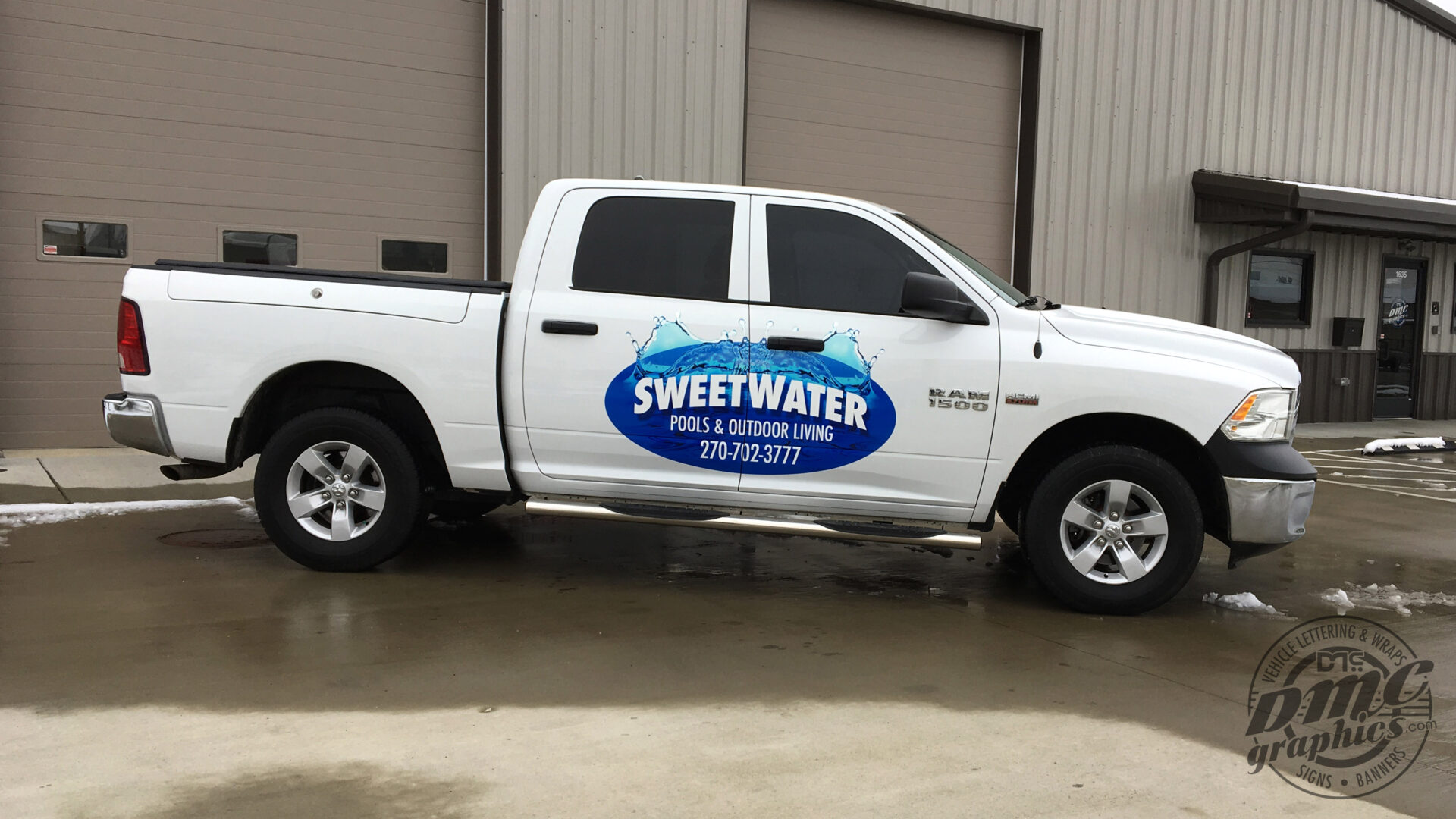 A white truck with a blue and white logo.