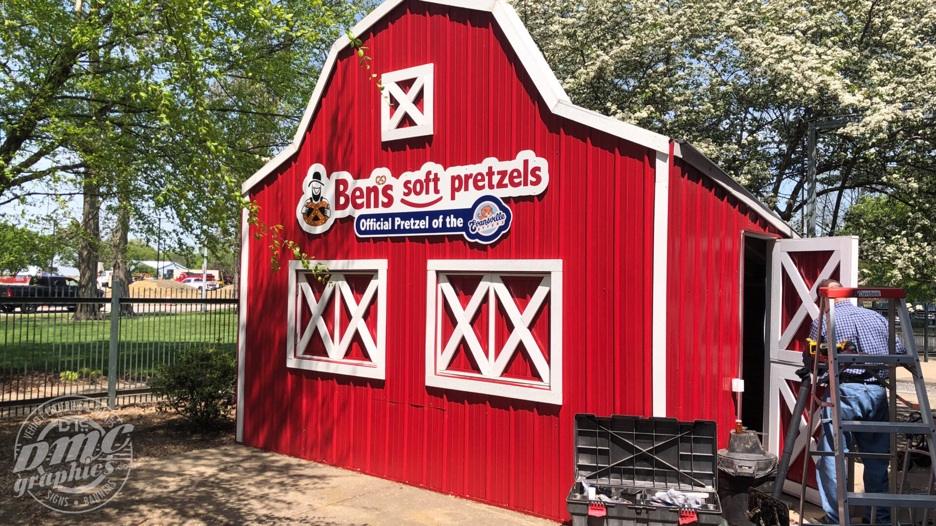 A red barn with a sign that says ben 's soft pretzels.