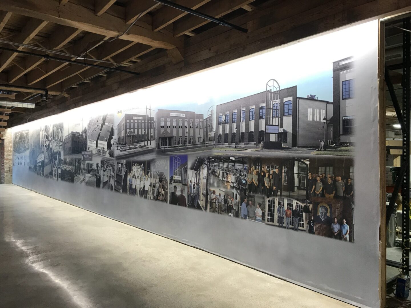 A large mural of people and buildings on the side of a building.