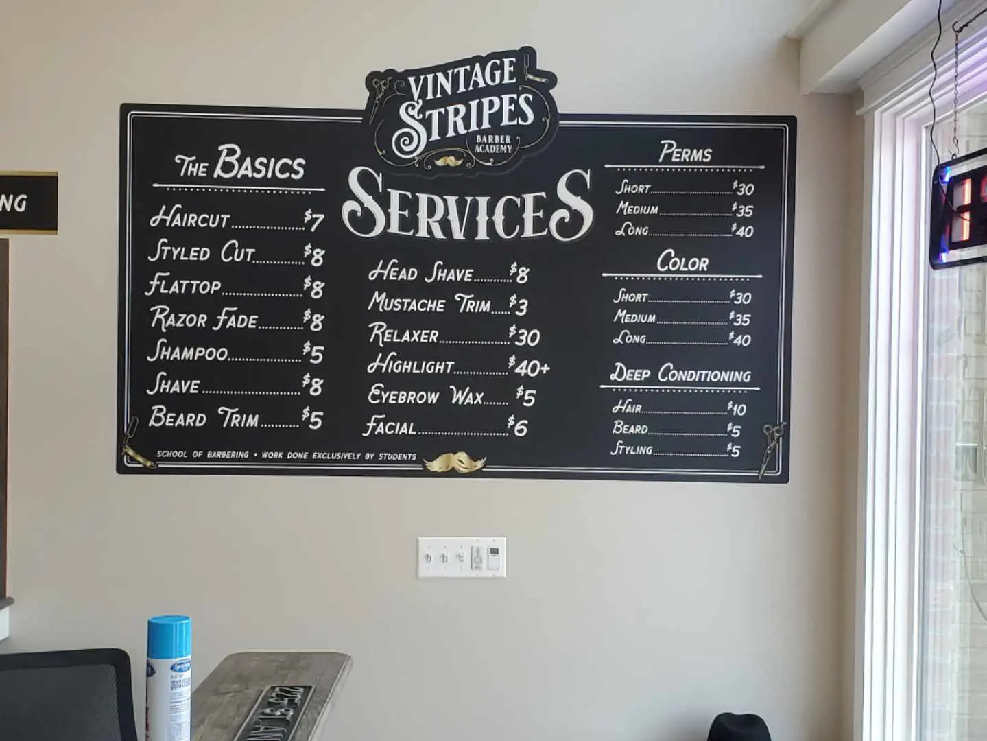 A chalkboard menu with the names of services.