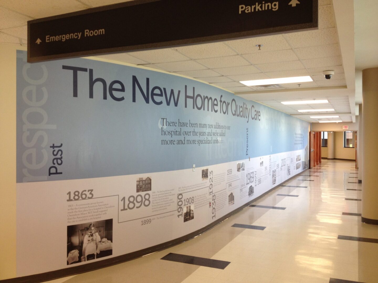 A hallway with many different pictures on the wall.