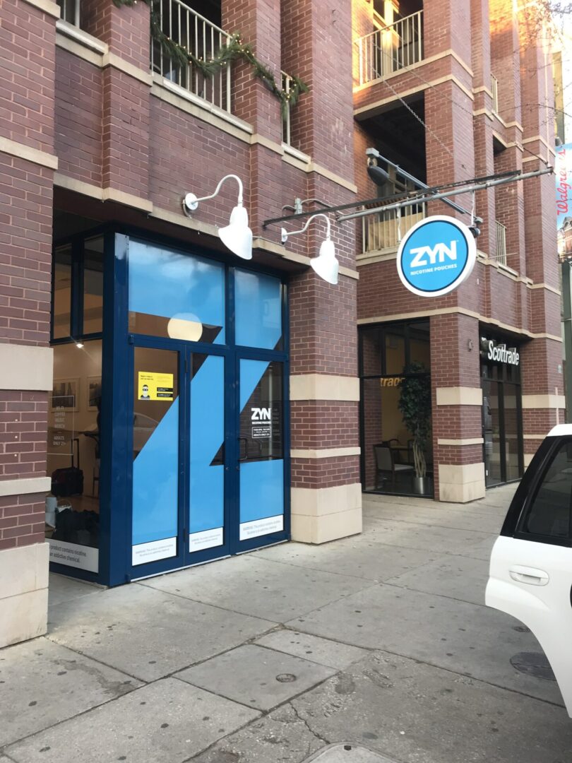 A blue door to an office building on the street.