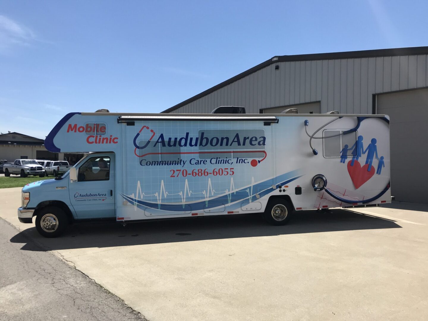 A large white truck parked in front of a building.