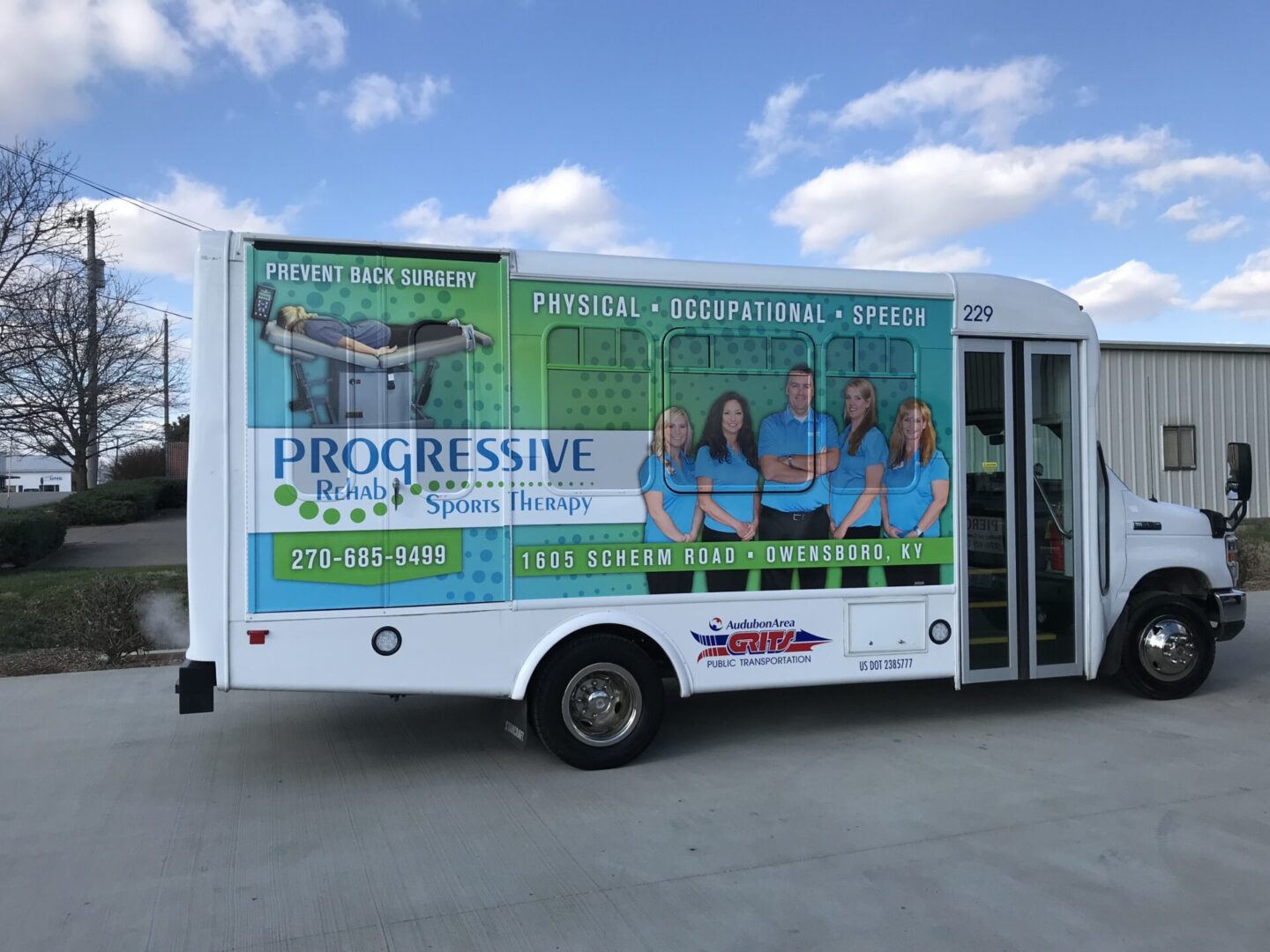 A bus with advertising on the side of it.