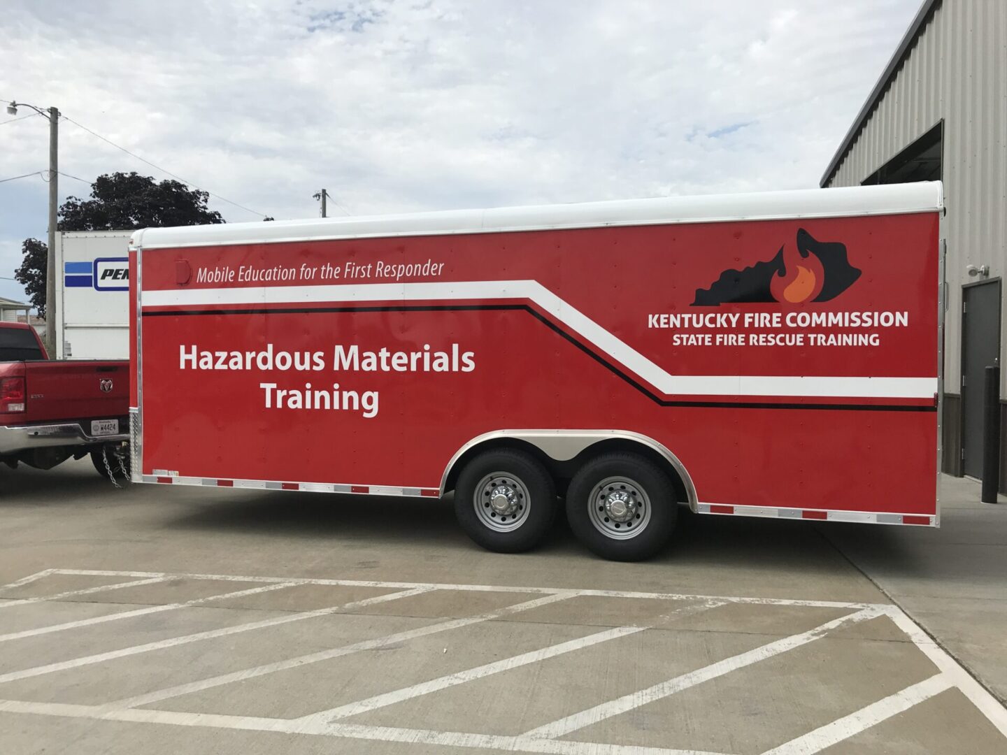 A red and white trailer parked in a parking lot.