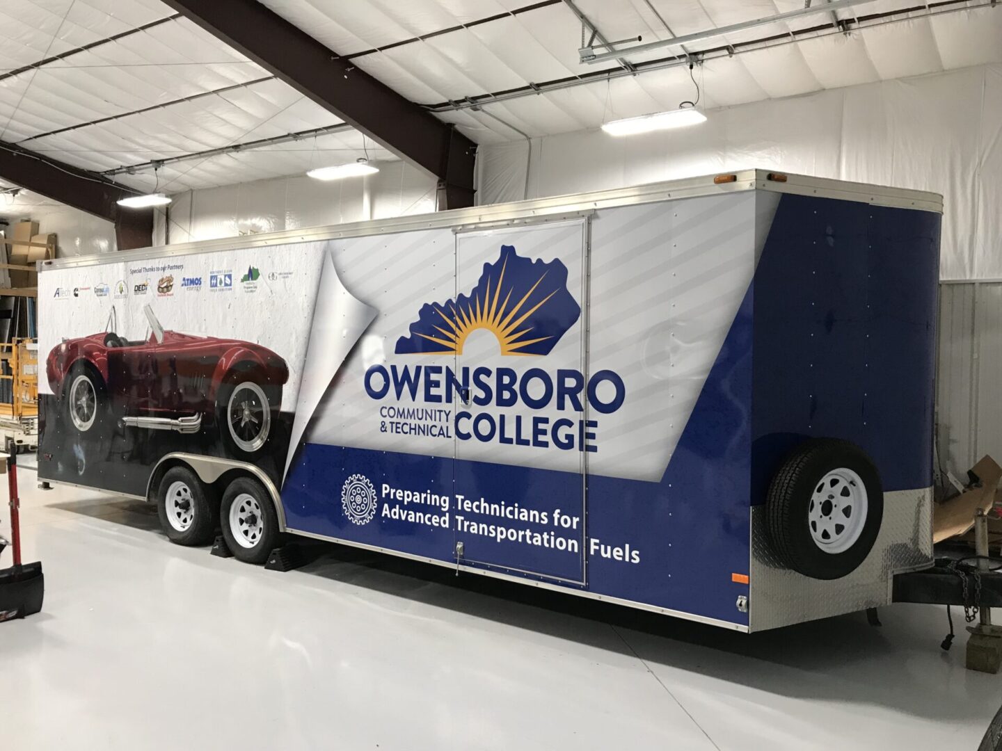 A trailer truck with the words owensboro electric college on it.