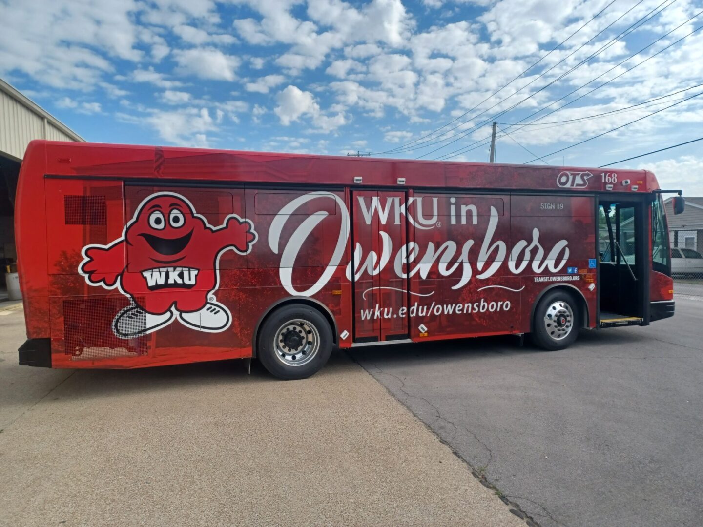 A wku bus parked on the side of the road.