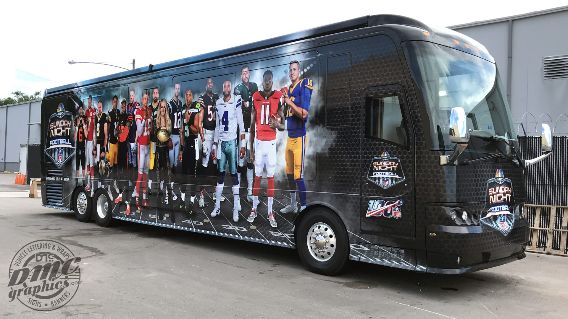 A bus with a large picture of football players on it.