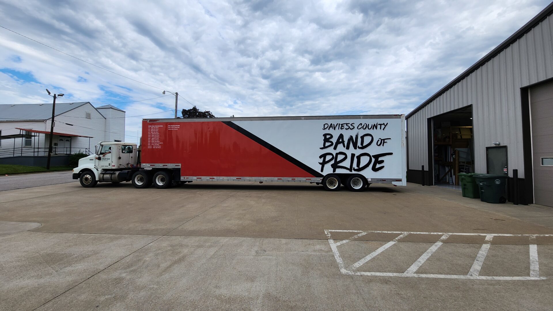 A red and white trailer parked in a parking lot.