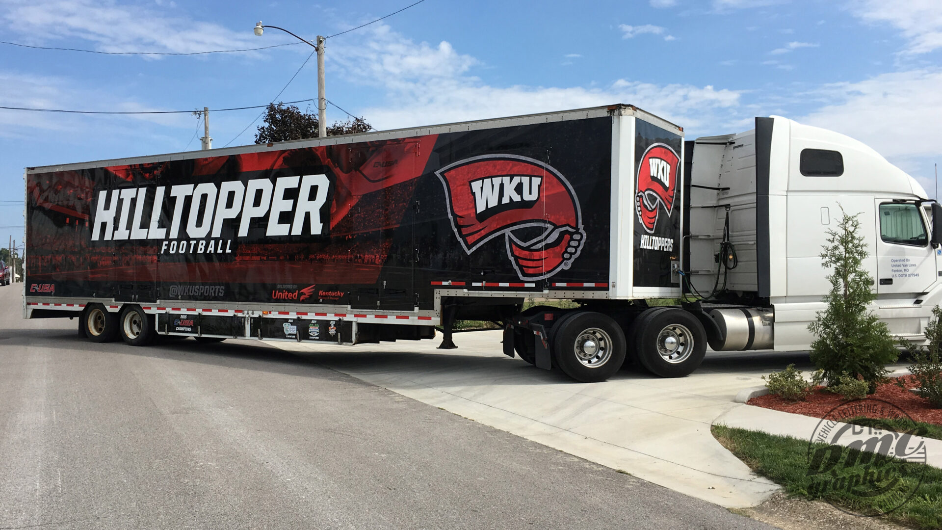 A large truck with the wku logo on it.