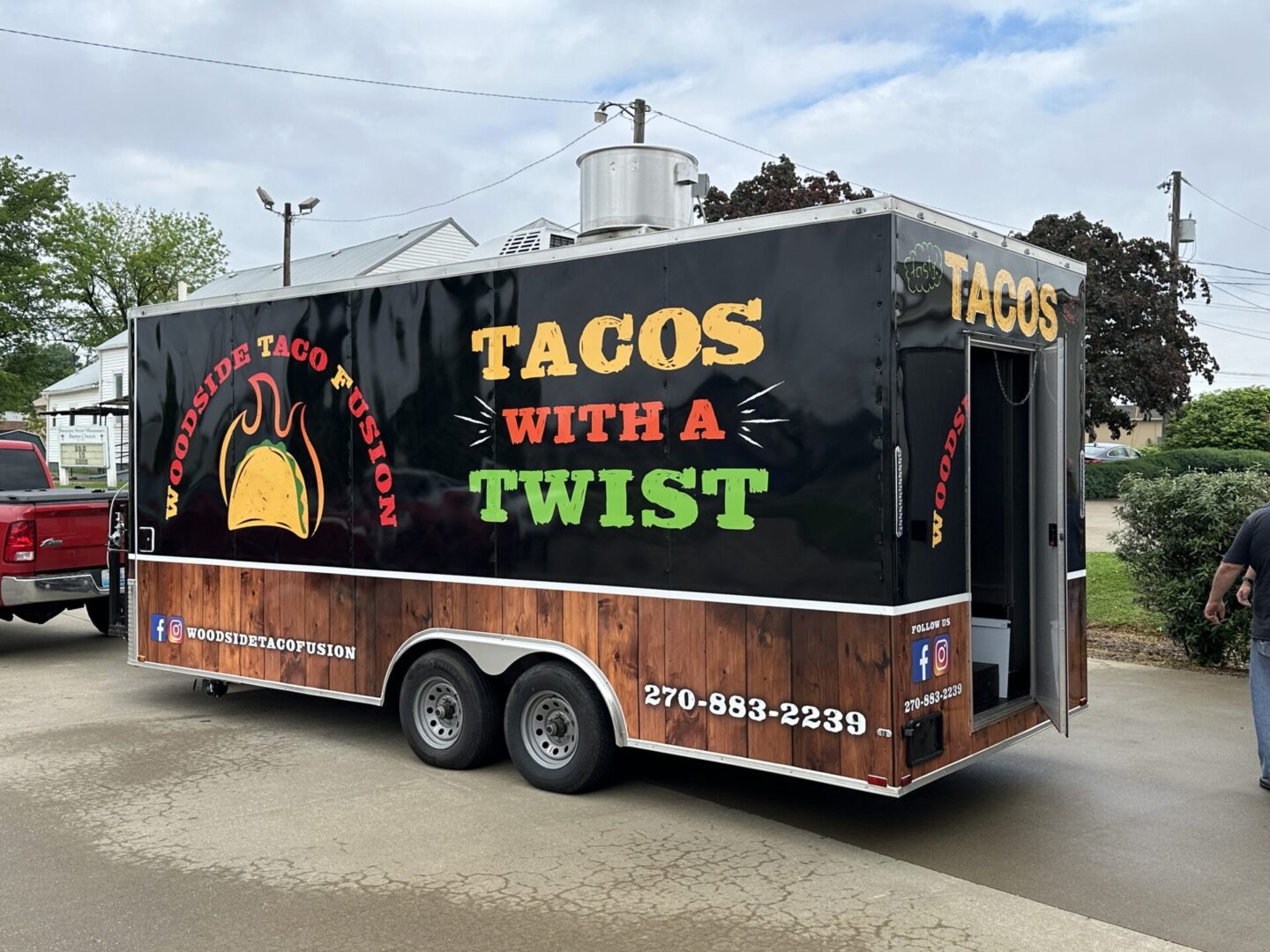 A taco truck parked on the side of the road.