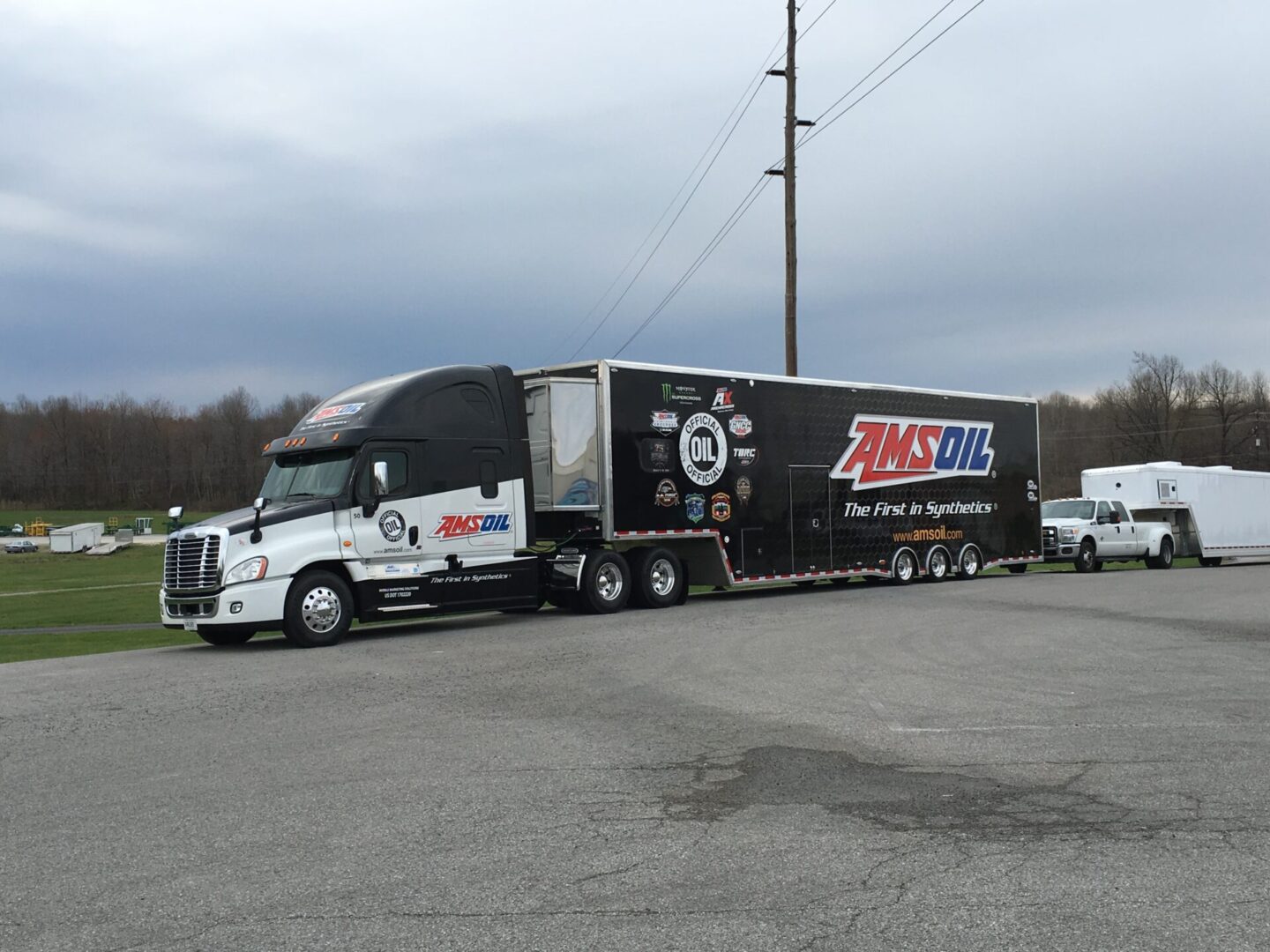 A semi truck with the trailer for race cars on it.