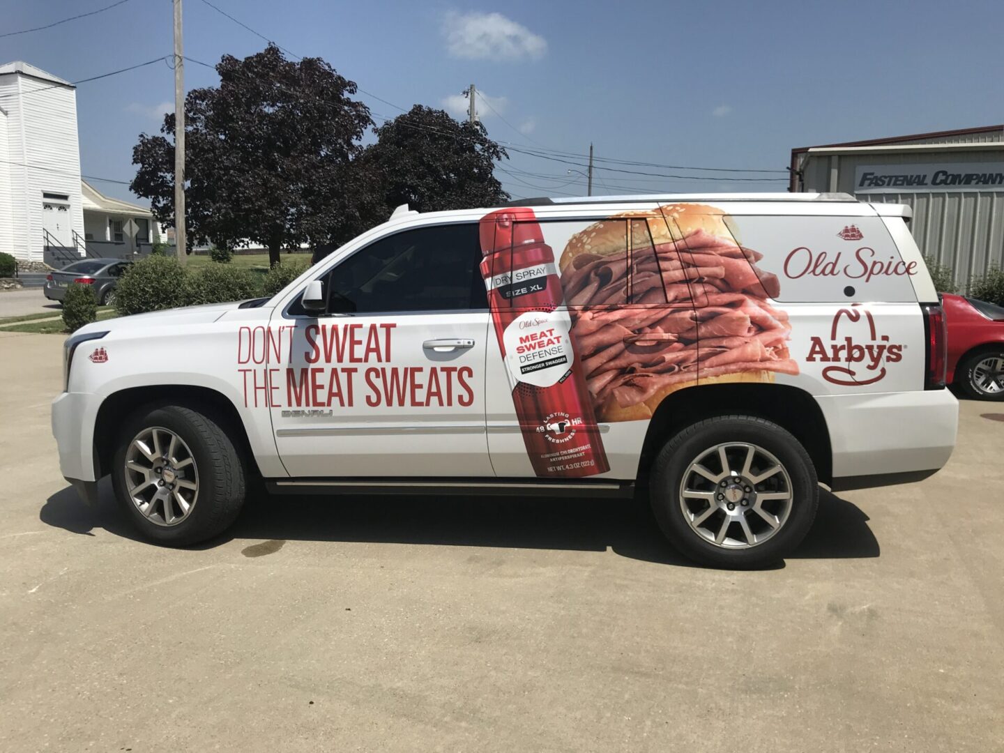 A white truck with advertising on the side of it.