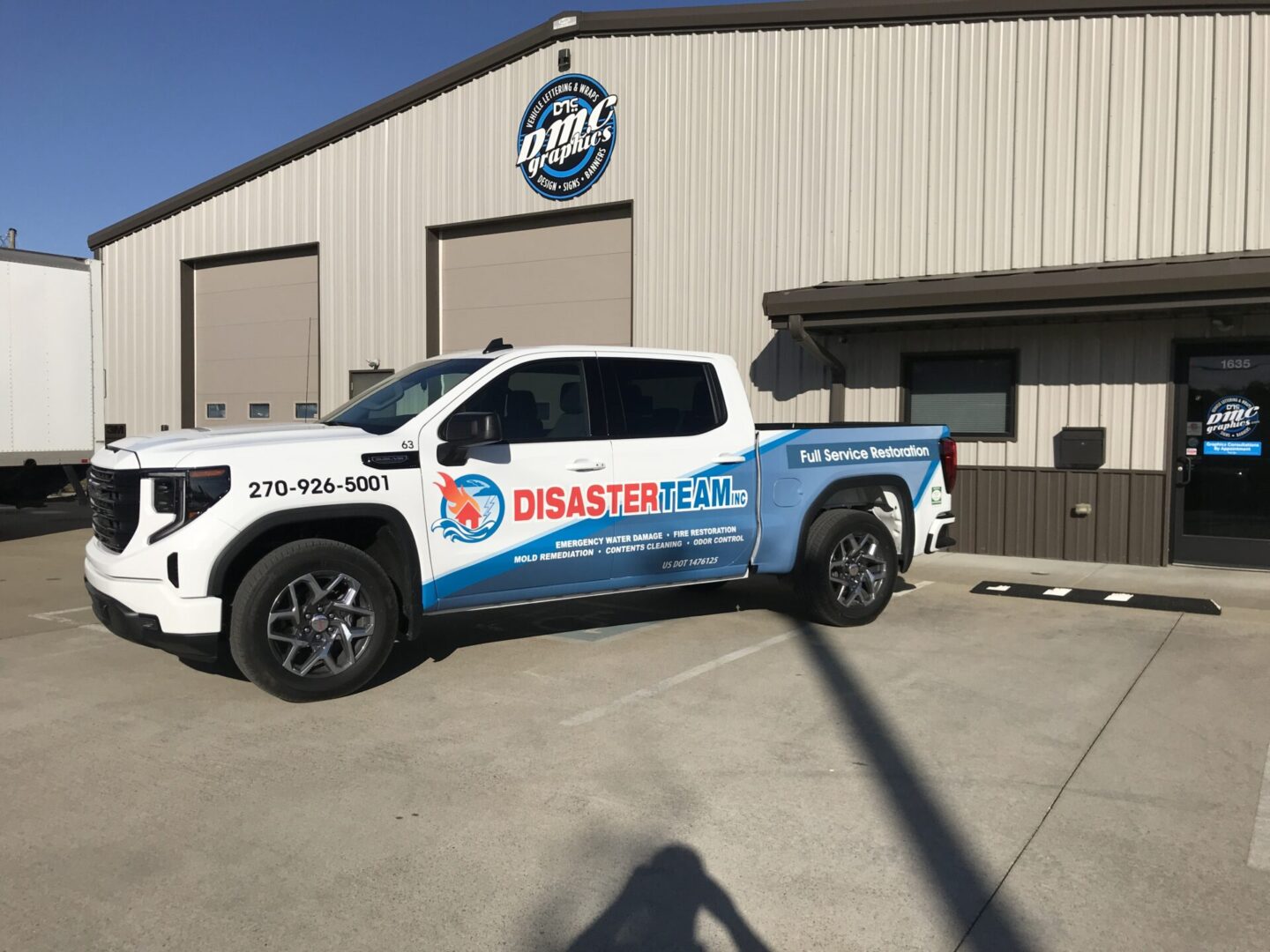 A white truck parked in front of a building.