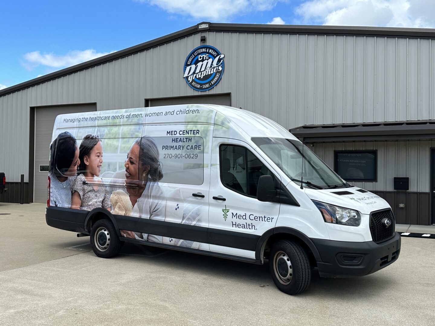 A white van parked in front of a building.