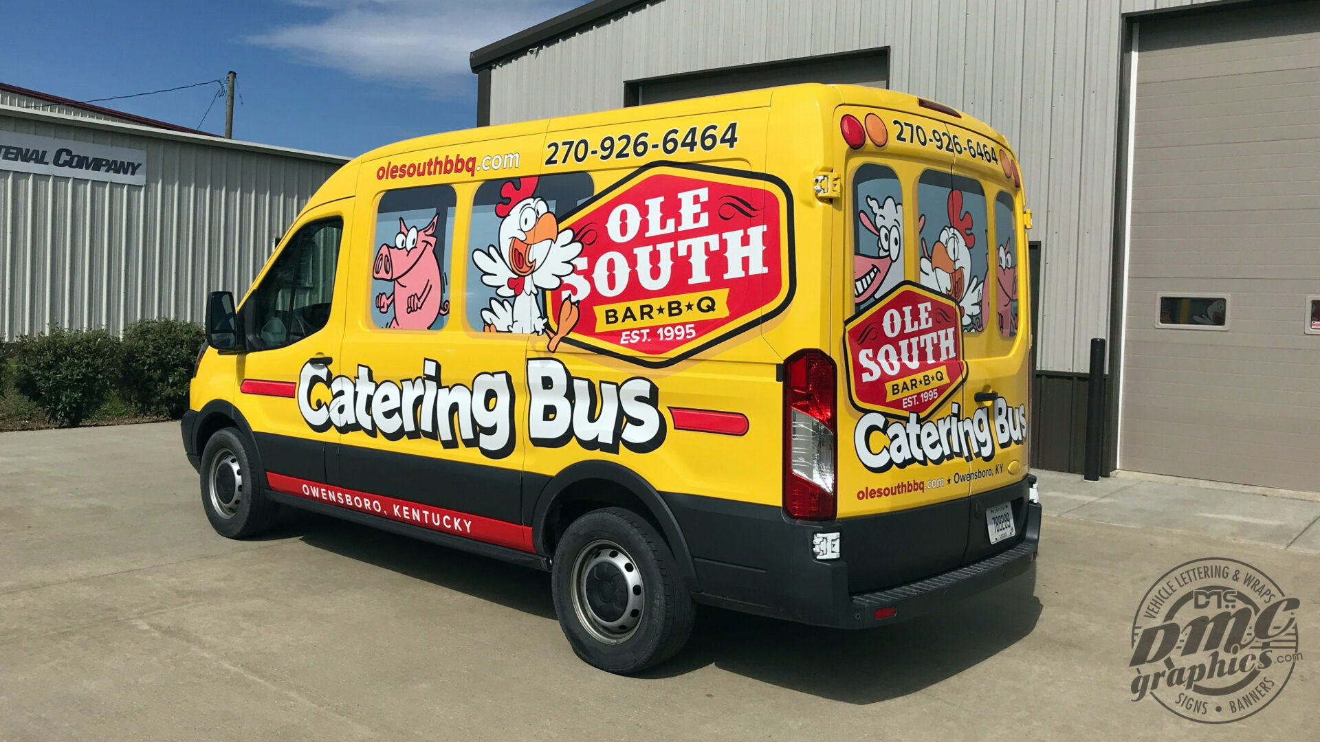 A yellow and red catering bus parked in front of a building.