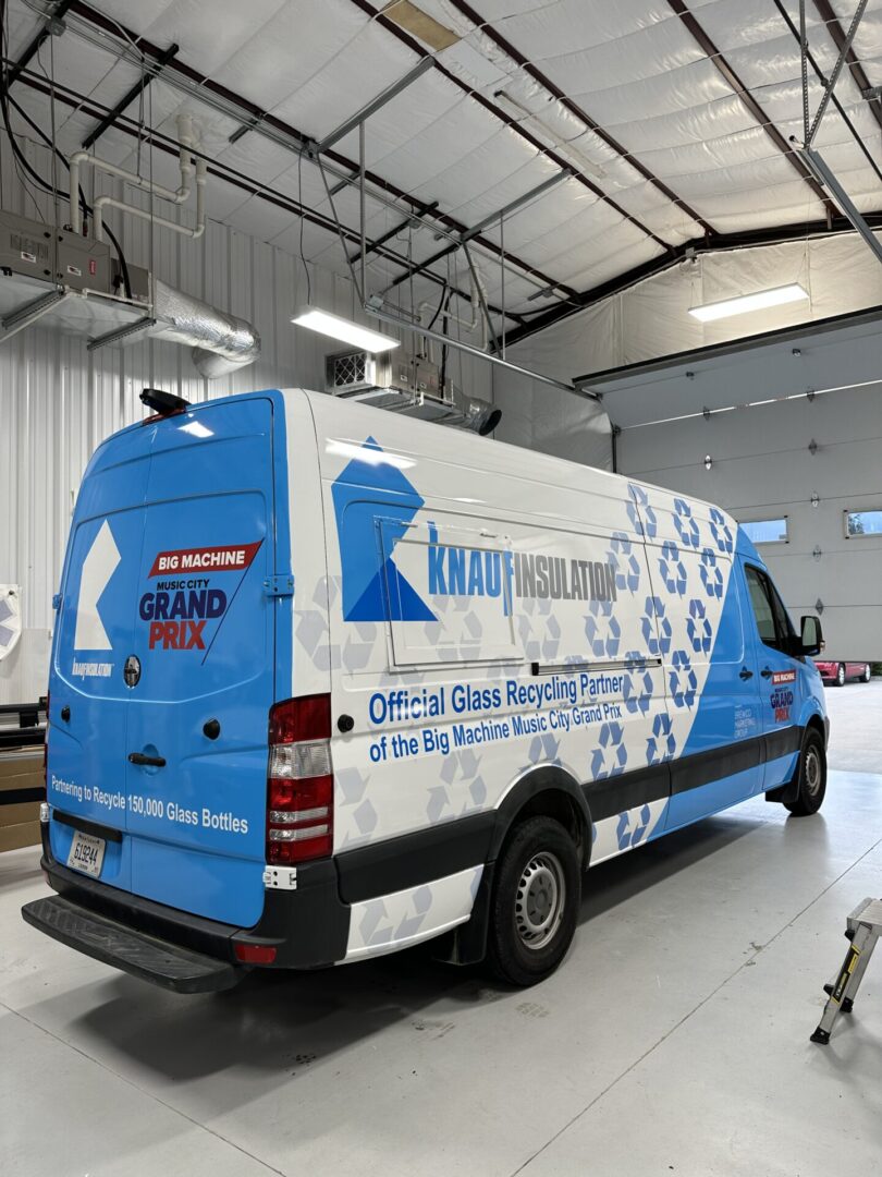 A van is parked in the garage with its side door open.