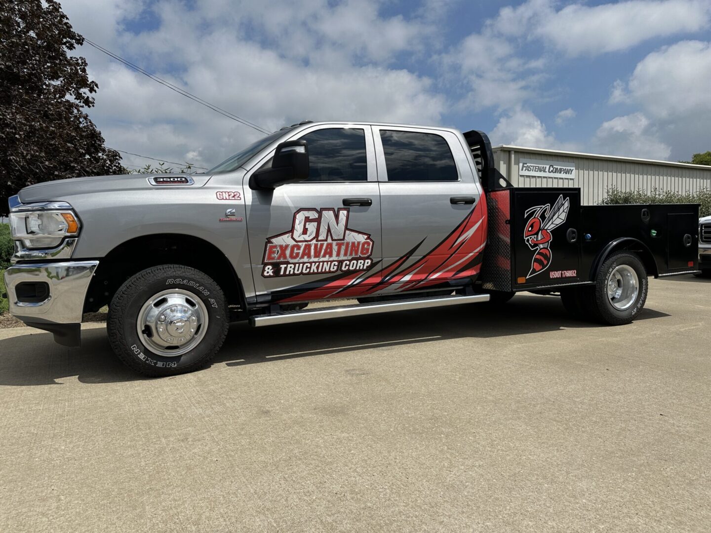 A truck with a large trailer parked on the side of the road.