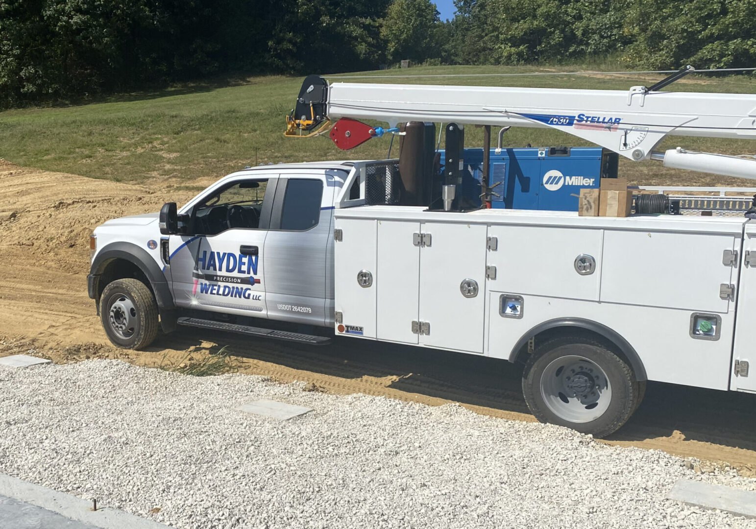 A white truck with a crane on the back