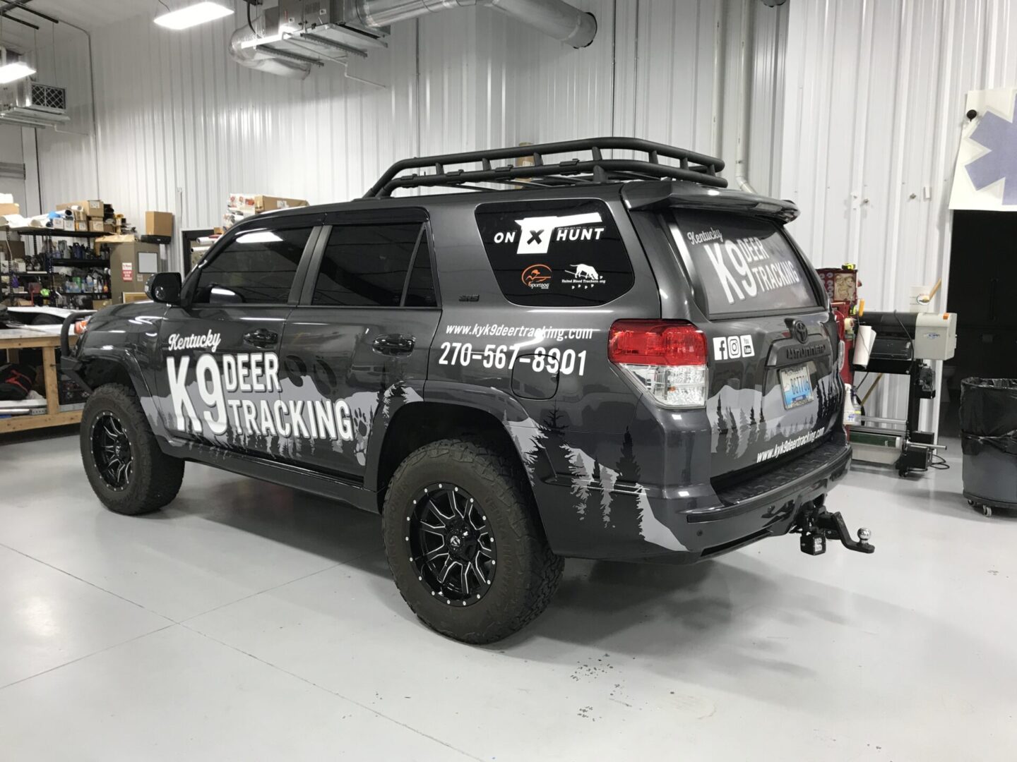 A black toyota 4 runner parked in a building.