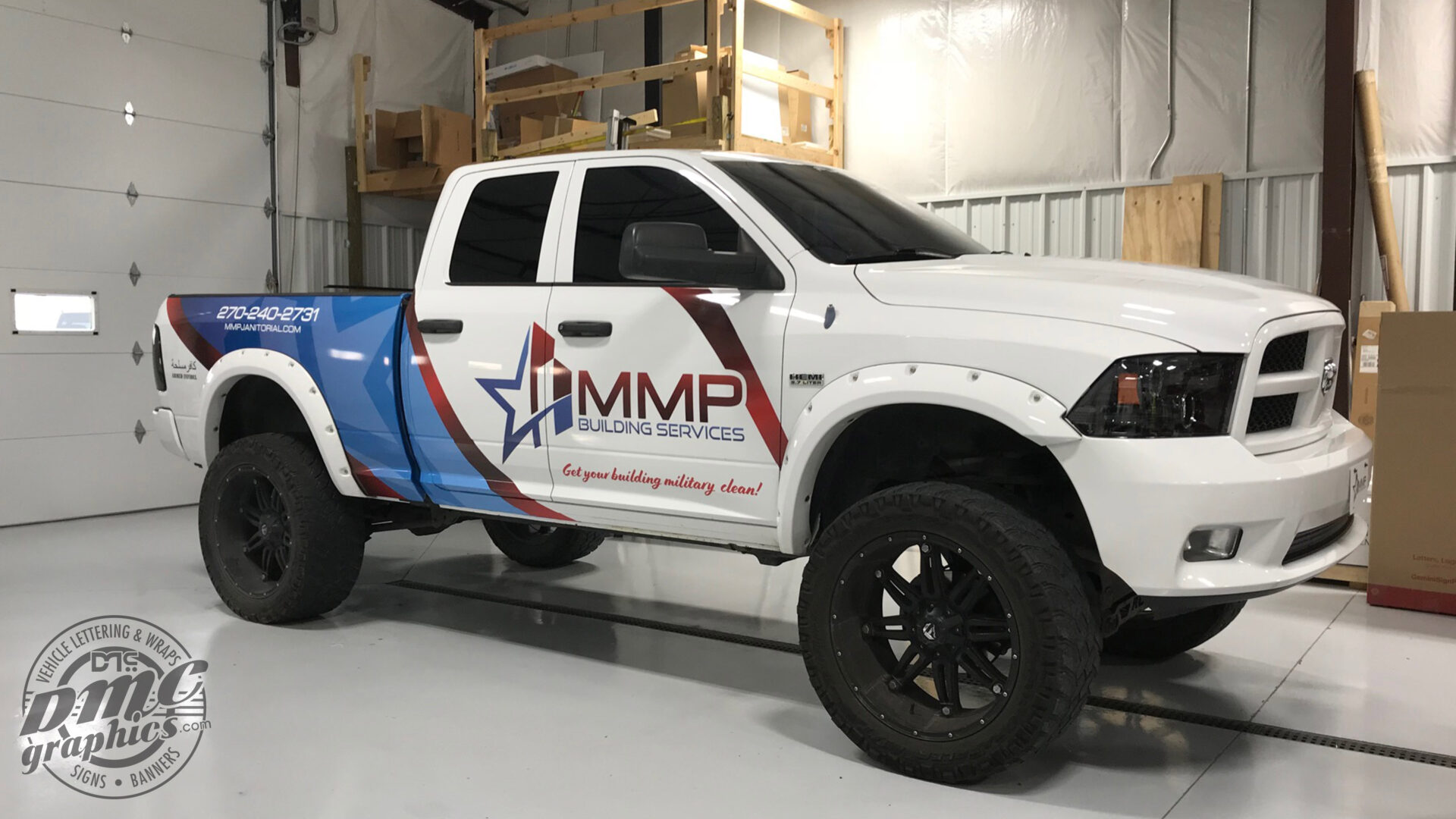 A white truck with immp logo on it.