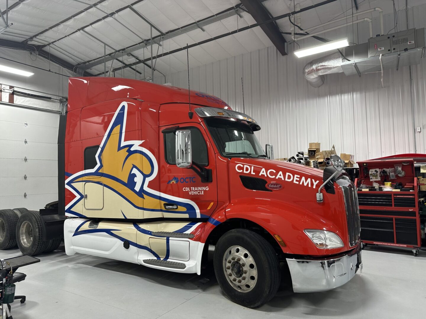 A red truck with an eagle on the side of it.