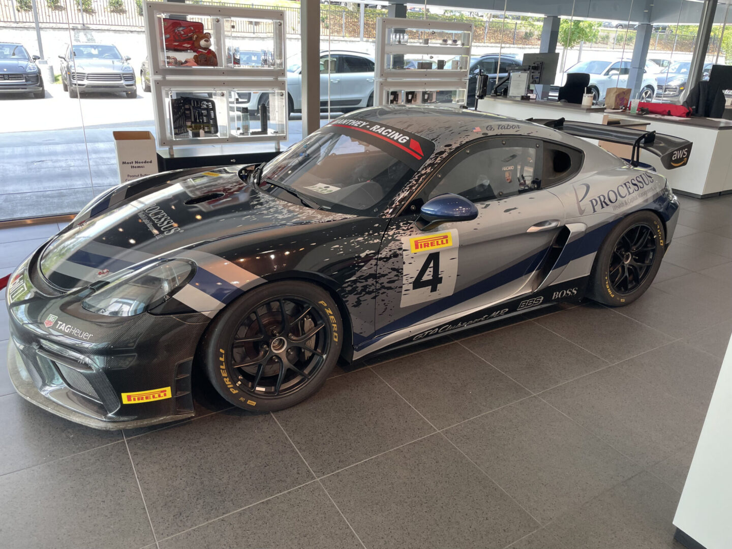 A black and silver car is parked in a showroom.