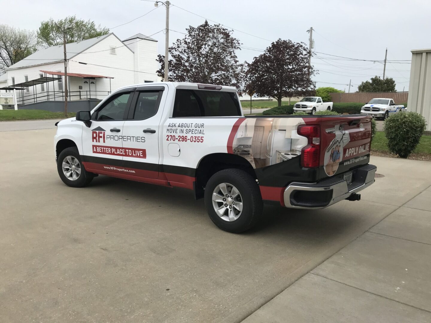 A truck parked in the parking lot of a home.