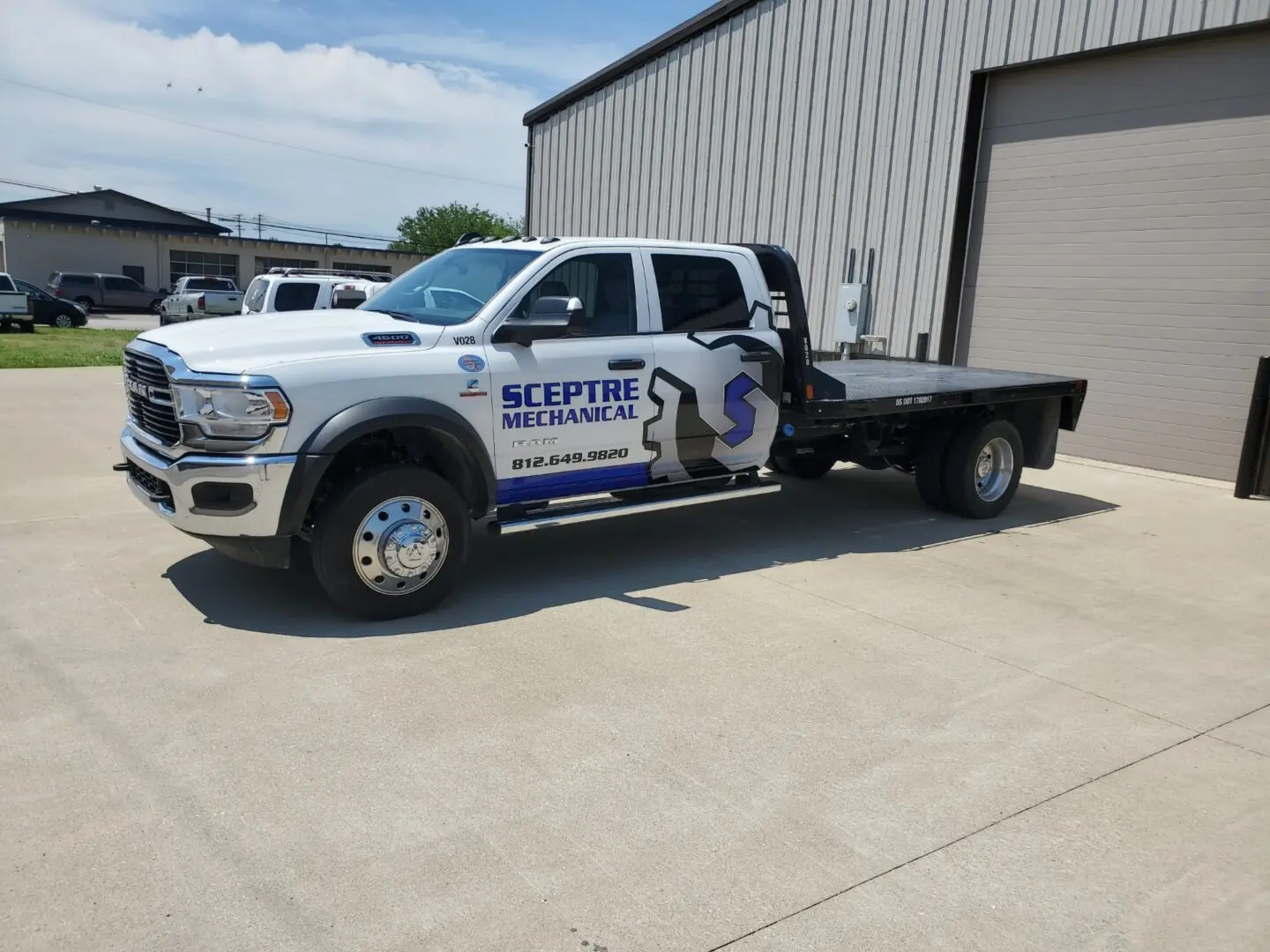 A white truck with a blue and black logo