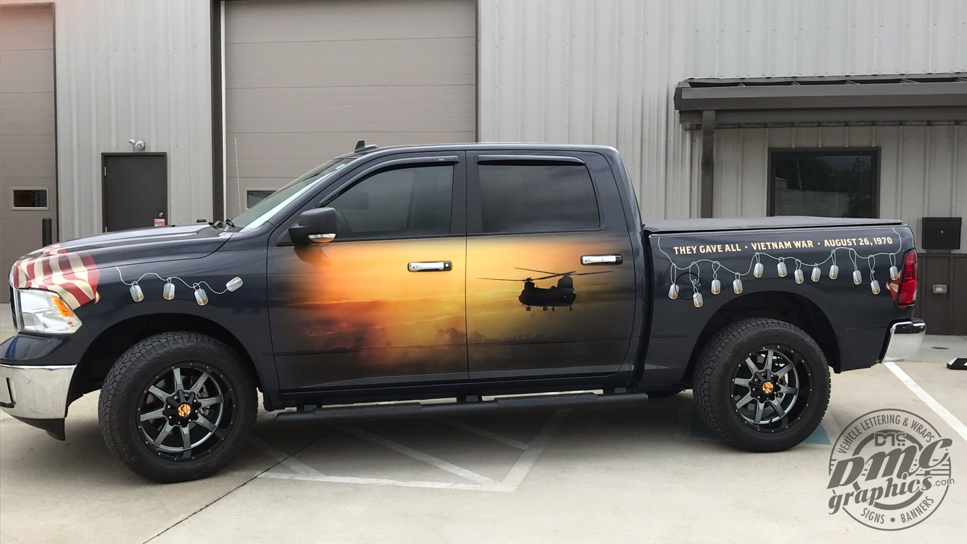 A truck with a fire painted on it's side.