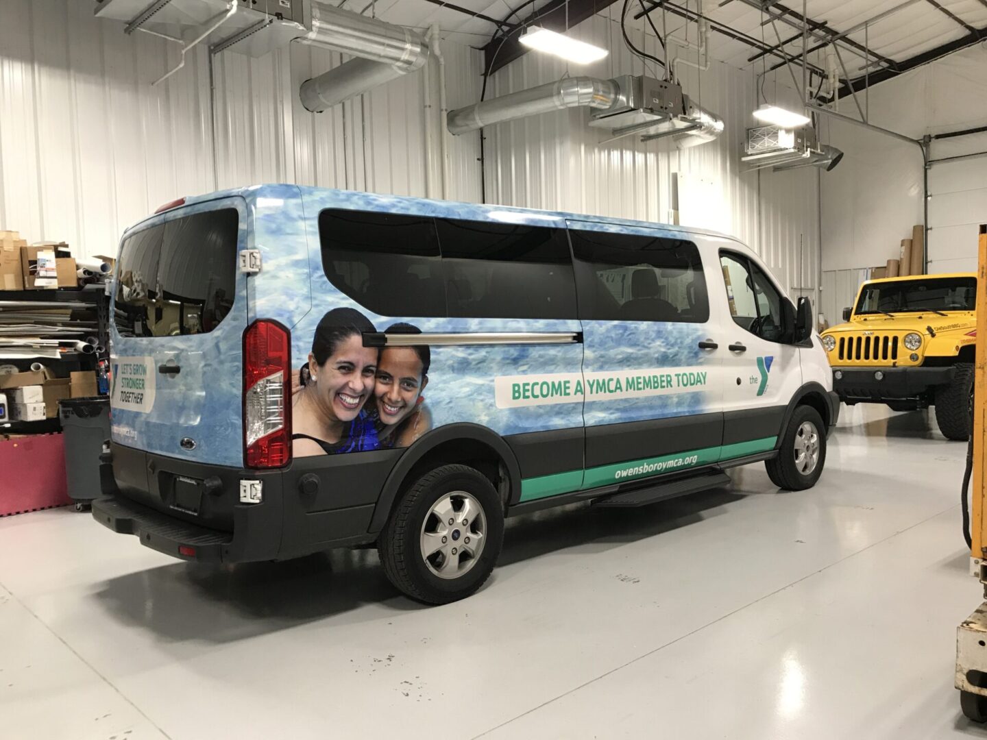 A van with a picture of two people on the side.