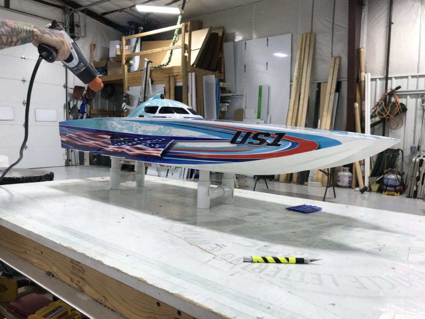 A man is working on a model boat.