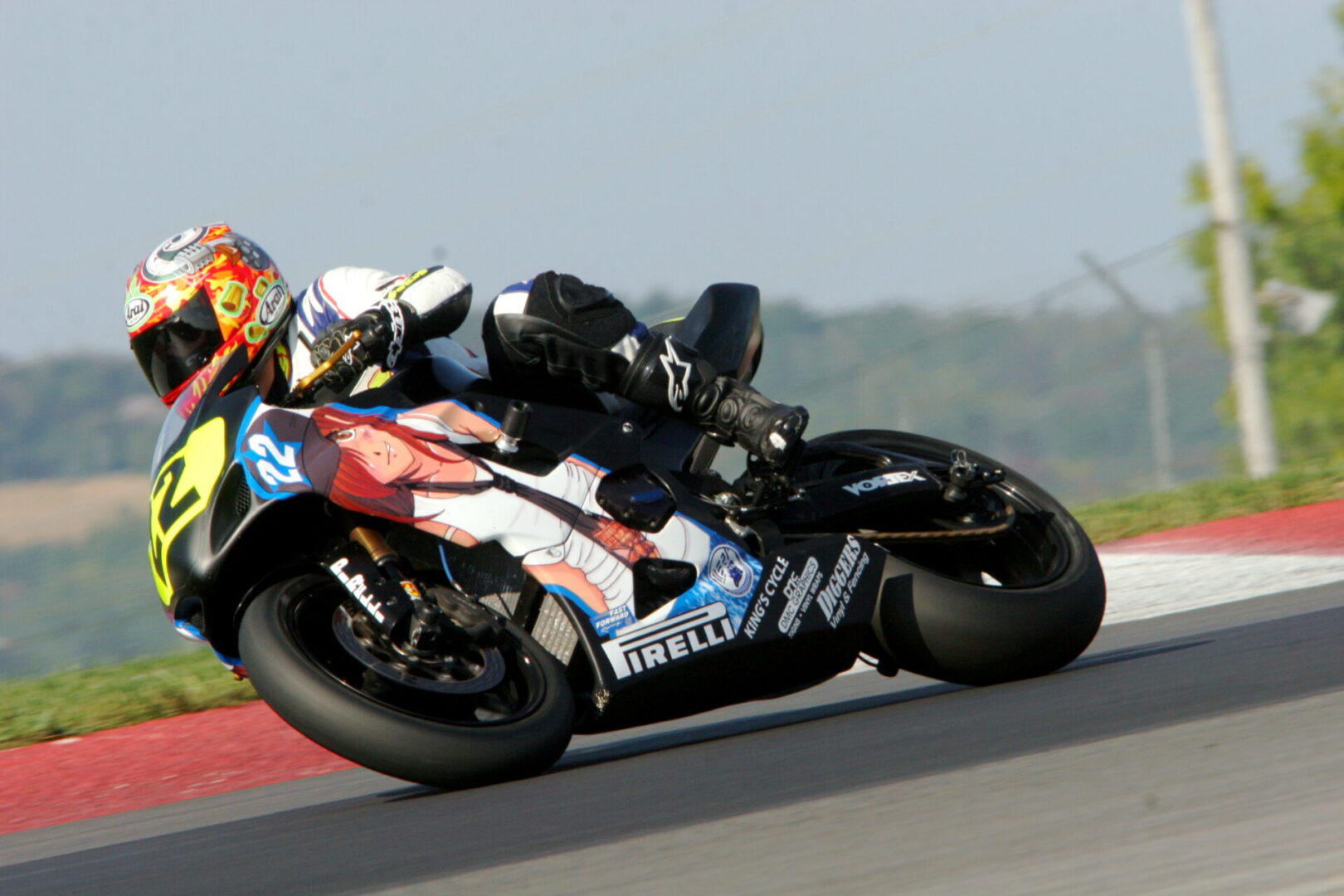 A person on a motorcycle riding down the road.