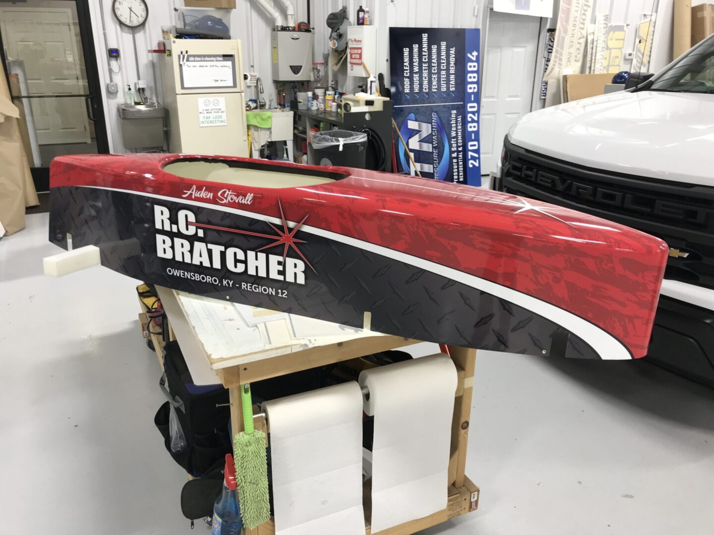 A red and black boat sitting on top of some paper.