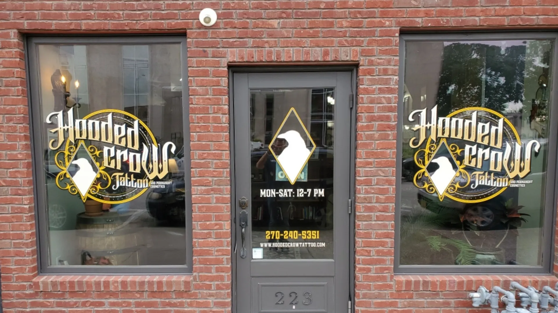 A store front with two windows and a door.