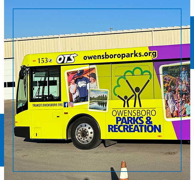 A yellow bus with images of people on it.