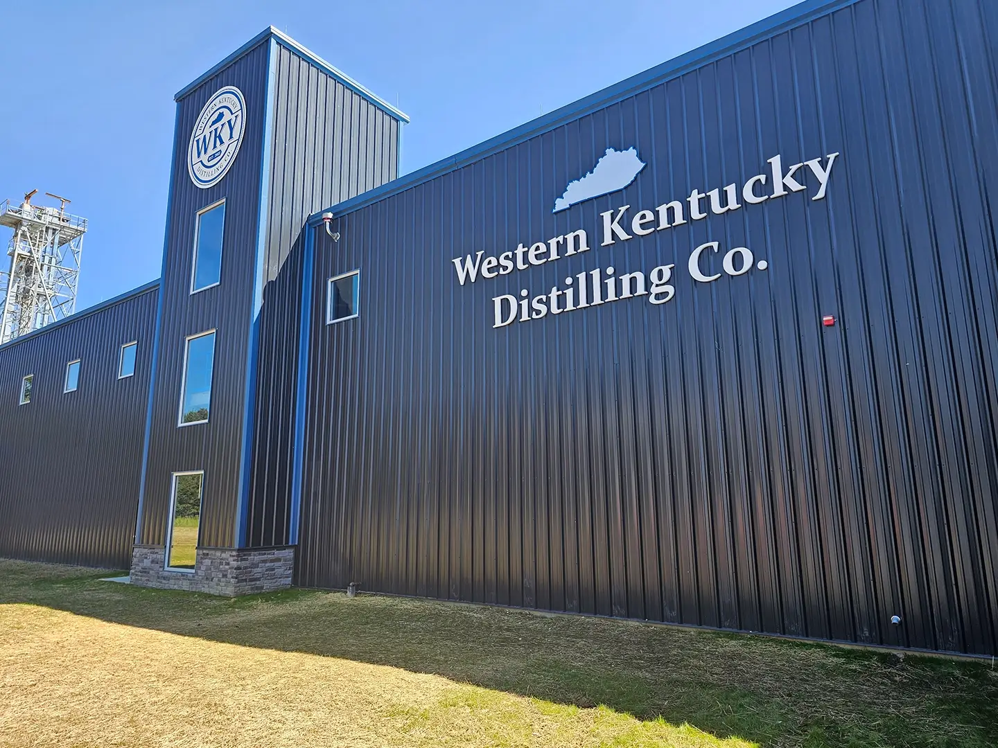 A black building with a clock on the side of it.